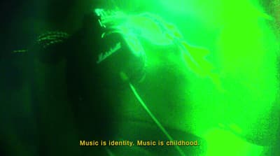 a person with headphones in a dark room