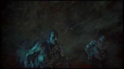 a blurry image of two people standing in the dark