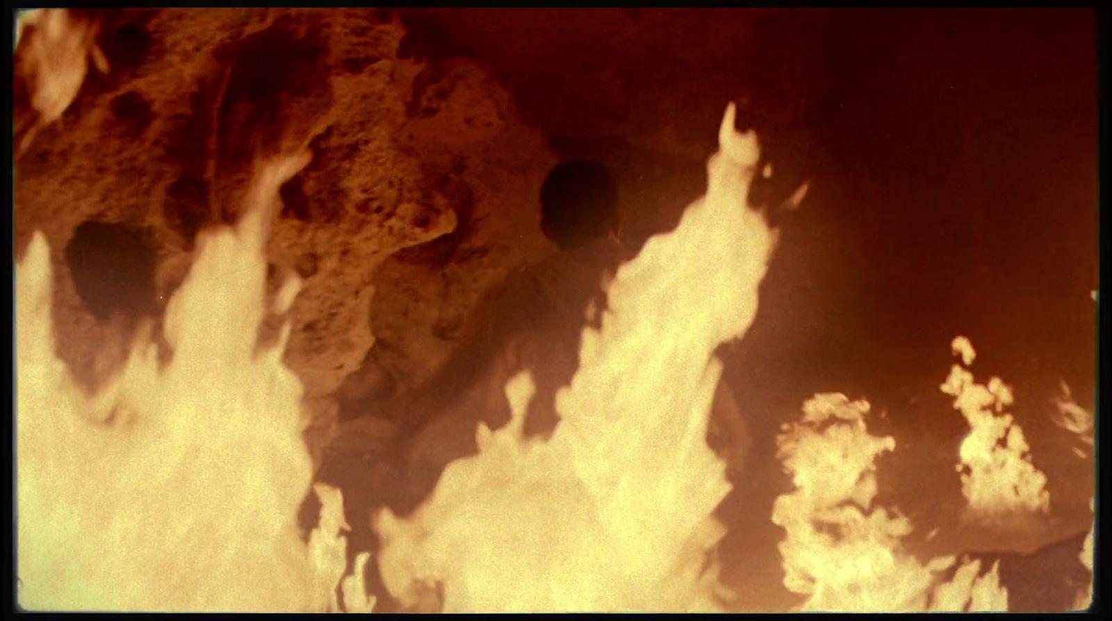a group of rocks with white smoke coming out of them