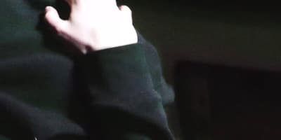 a person with their hand on a cell phone