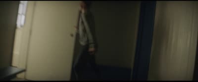 a person standing in a room with a door open
