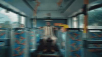 a blurry photo of a man riding a bus