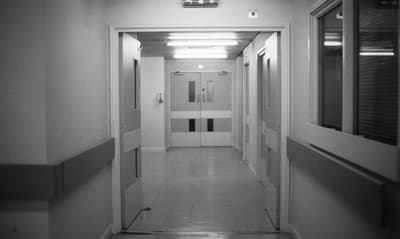 a long hallway with white walls and doors