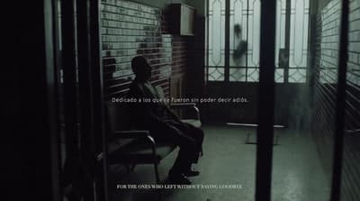 a man sitting on a bench in a dark room