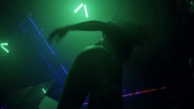 a person standing in front of a green light