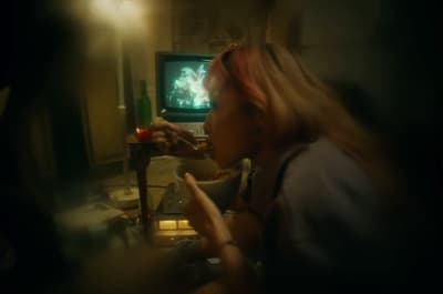 a blurry photo of a woman in front of a television