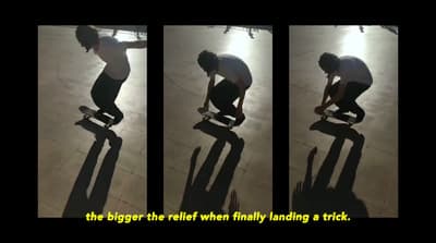 a man riding a skateboard on top of a wooden floor