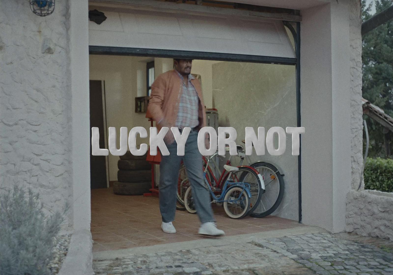 a man walking out of a garage with a bicycle
