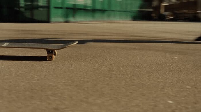 a skateboard laying on the ground in a parking lot