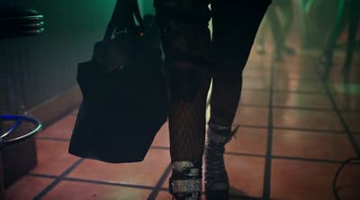 the legs of a woman in fishnet stockings and high heels