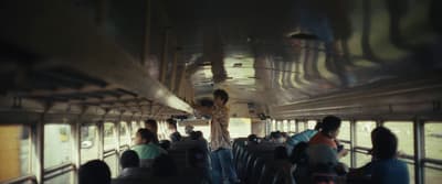 a group of people riding on top of a bus