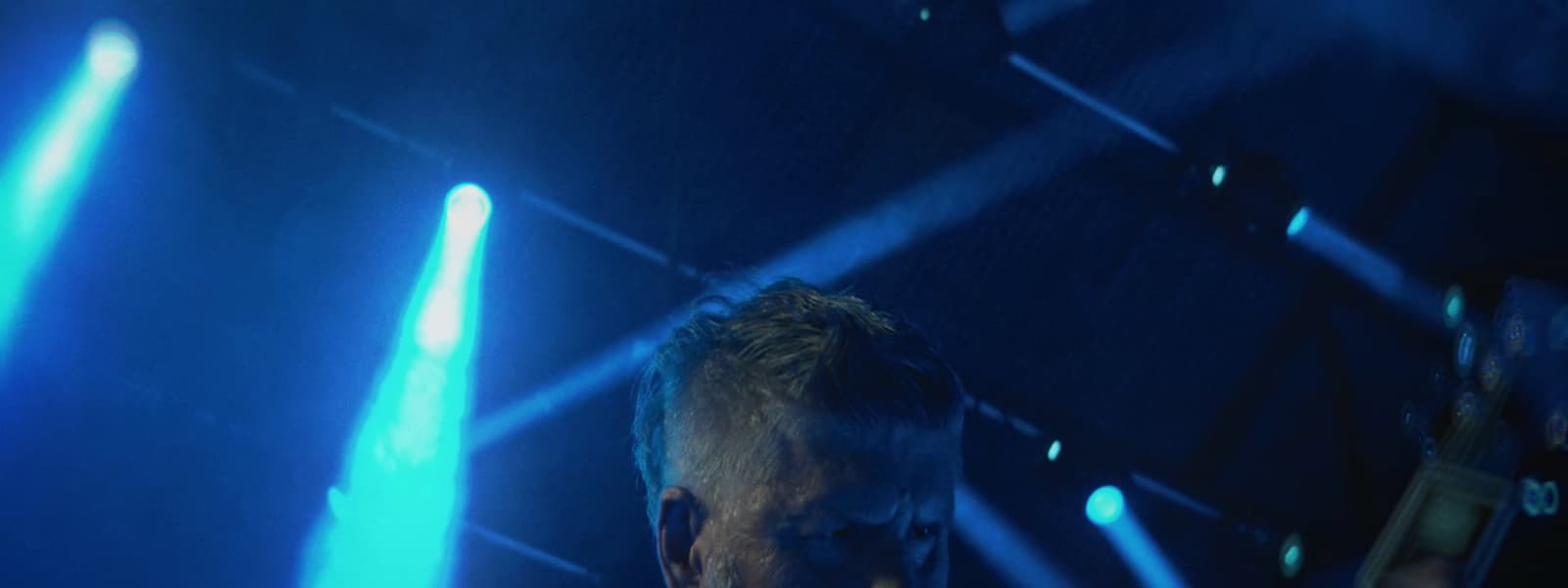 a man standing in front of blue lights