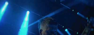 a man standing in front of blue lights