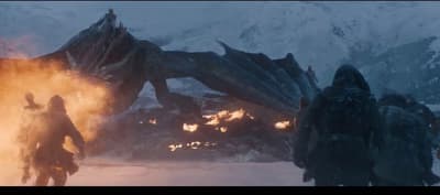 a group of people standing in front of a dragon
