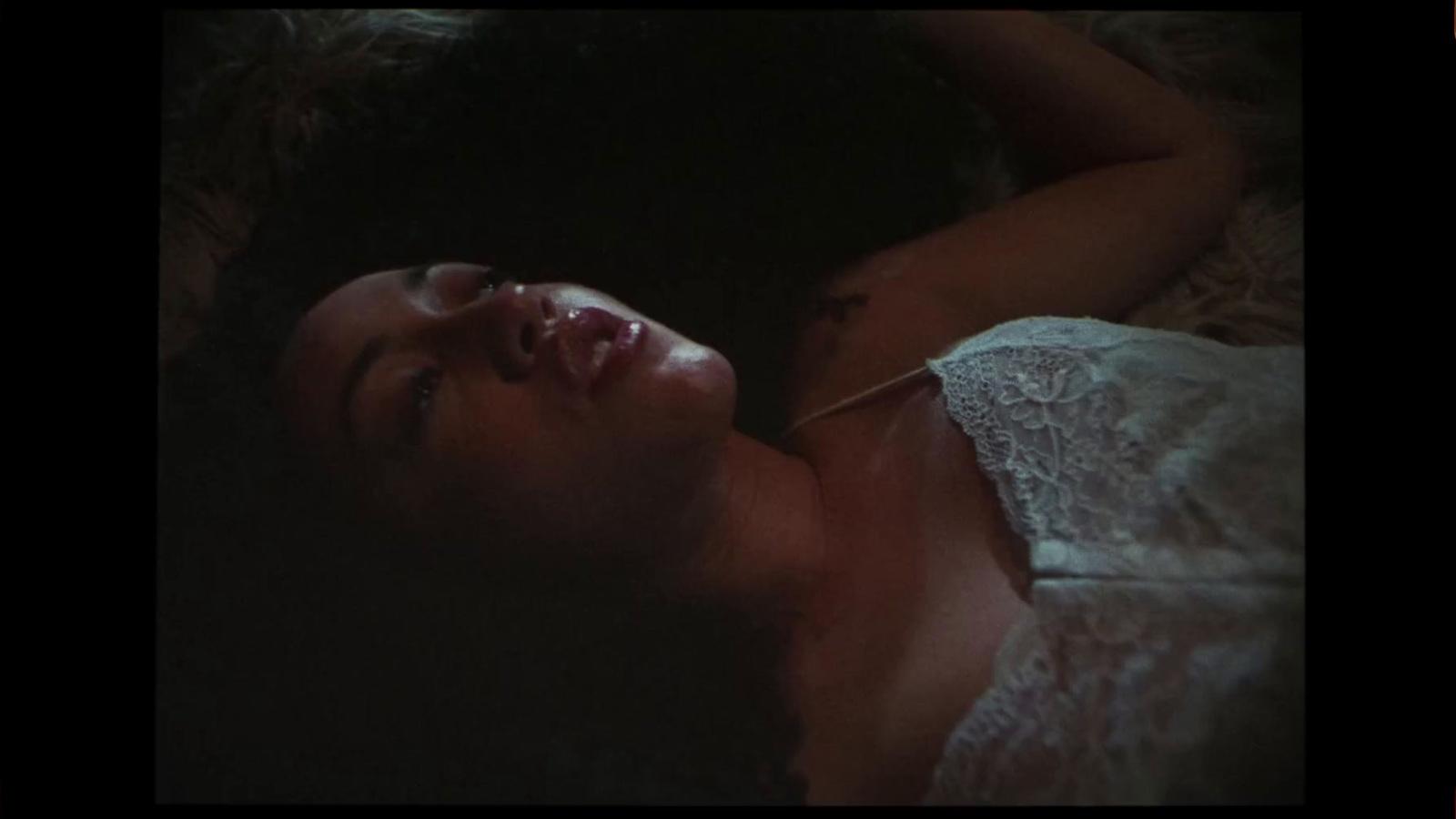 a woman laying in bed with her eyes closed