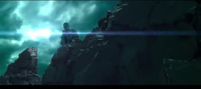 a man standing on top of a rocky cliff