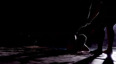 a person standing in the dark with their feet on the ground