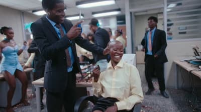 a man sitting in a wheel chair next to a woman