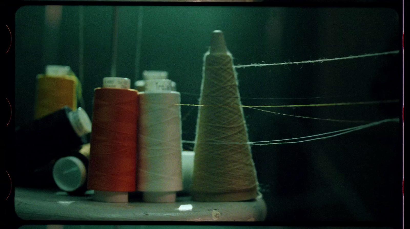 a group of spools of thread sitting next to each other