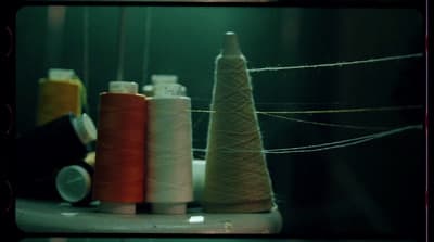 a group of spools of thread sitting next to each other