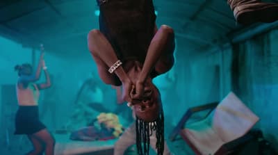 two people hanging upside down in a room