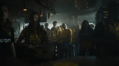 a group of people standing around a bar