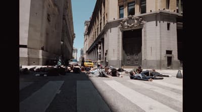 a group of people laying on the side of a road
