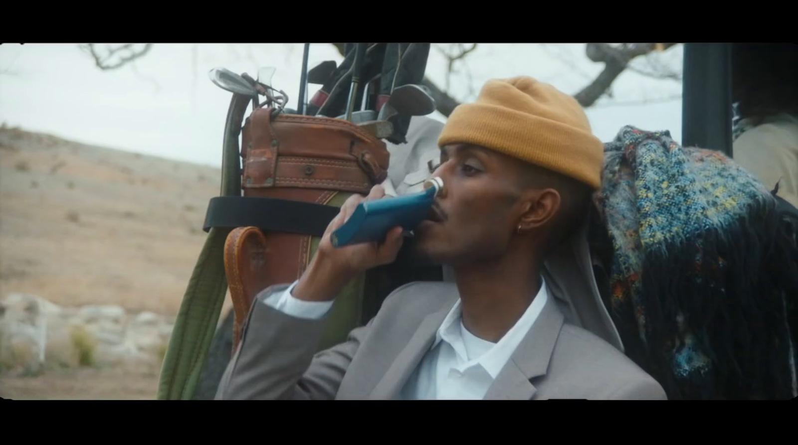 a man in a suit talking on a cell phone