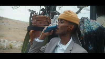 a man in a suit talking on a cell phone