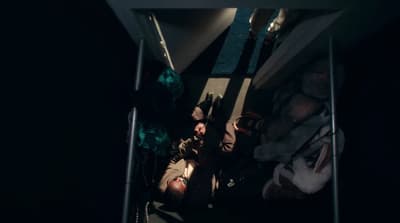a group of people laying on the ground in the dark