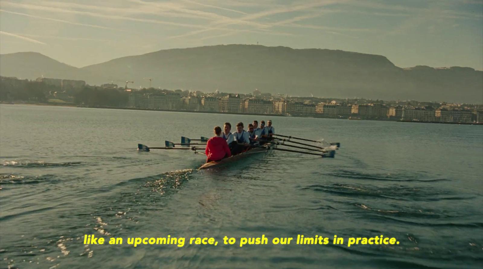 a group of people rowing a boat in the water