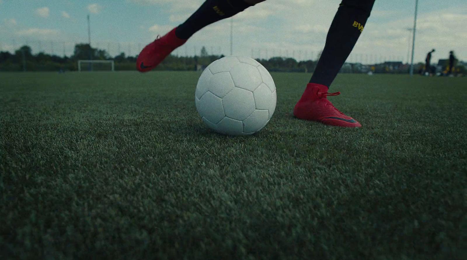 a person kicking a soccer ball on a field