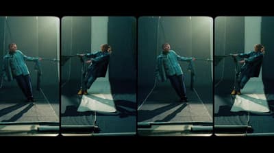 a woman in a blue shirt is holding a rope