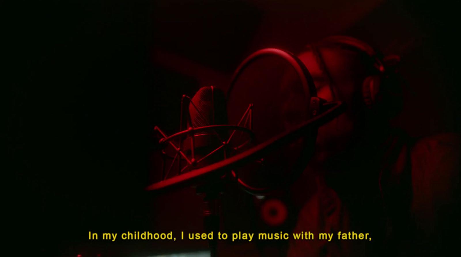 a dark room with a red light and a quote