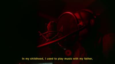 a dark room with a red light and a quote