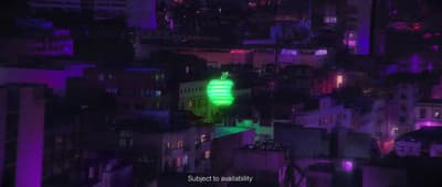 a green light on top of a building in a city