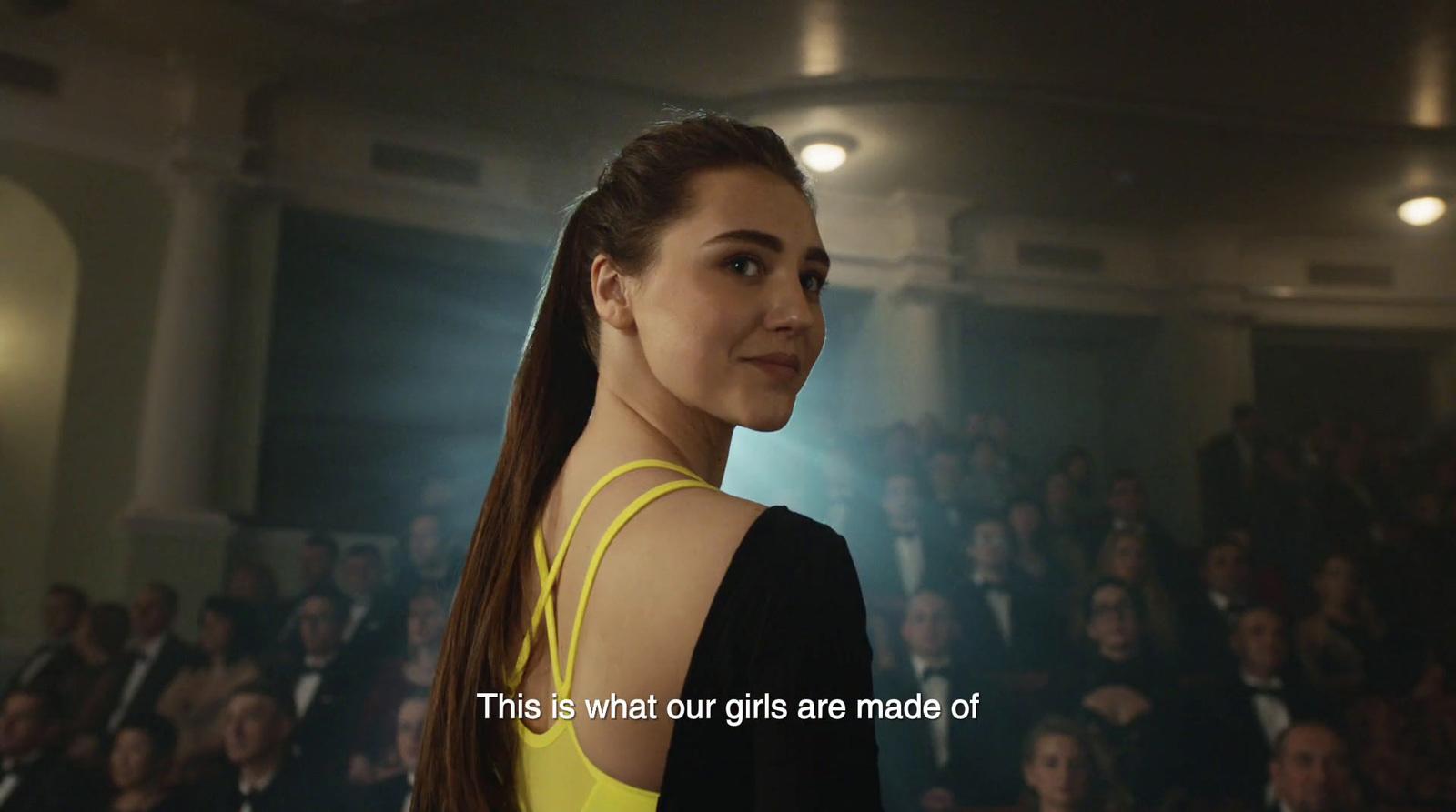 a woman standing in front of a crowd of people