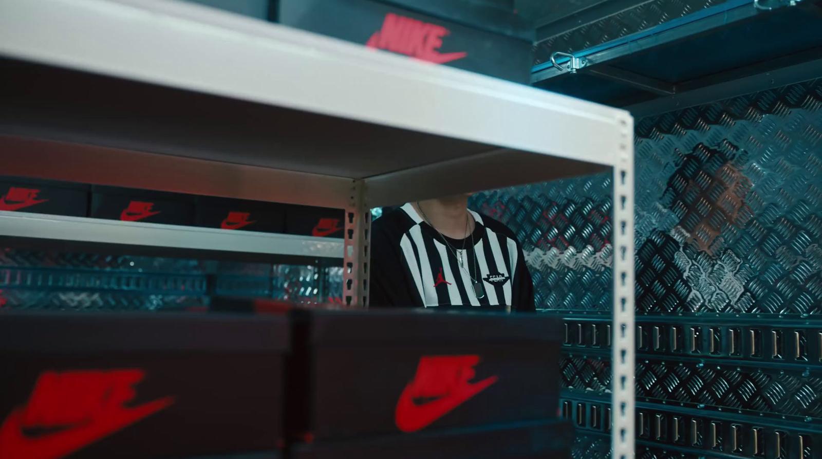 a man in a black and white striped shirt standing in a locker