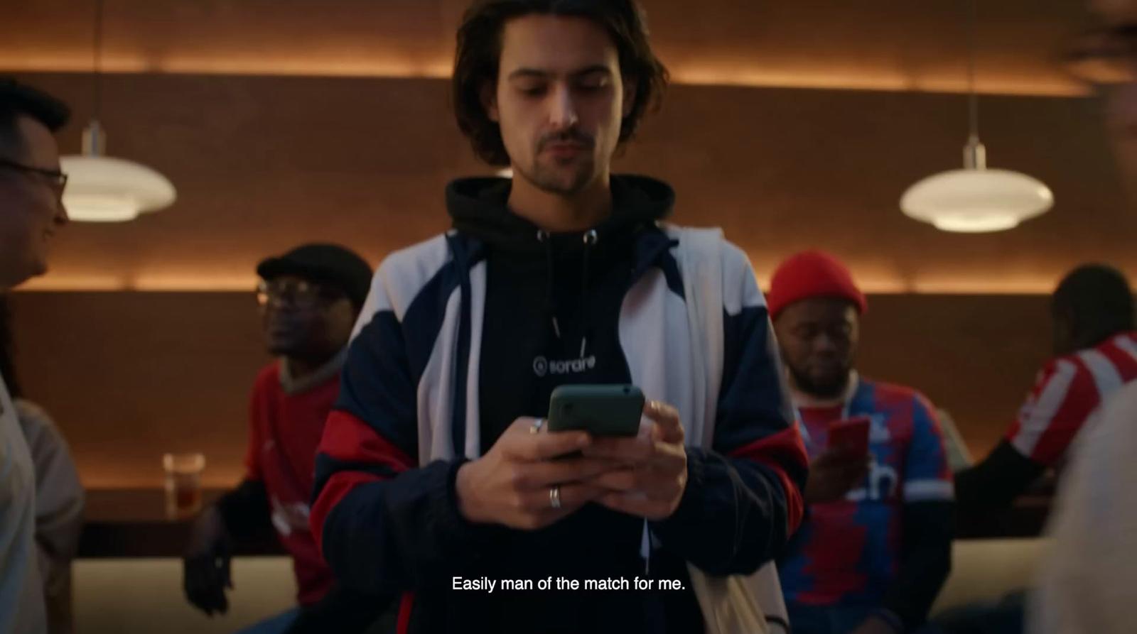 a man looking at his cell phone in a group of people