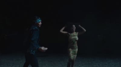 a man and a woman walking in the dark