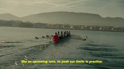 a group of people rowing a boat in the water