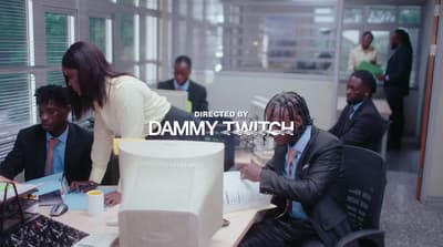 a group of people sitting around a desk in an office