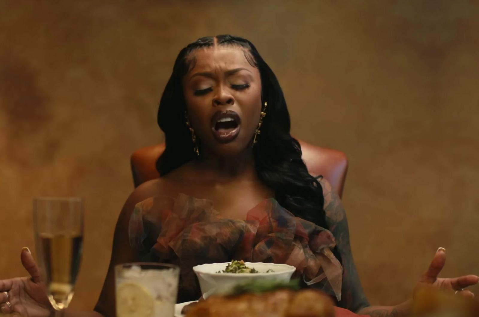 a woman sitting at a table with a plate of food