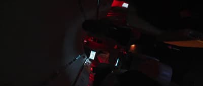 a person standing in a dark room holding a cell phone