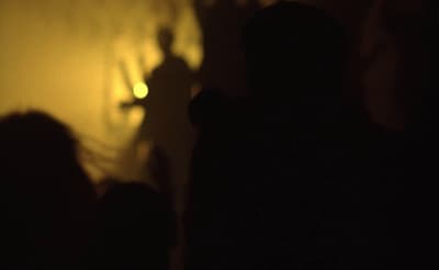 a blurry photo of a person standing in front of a wall