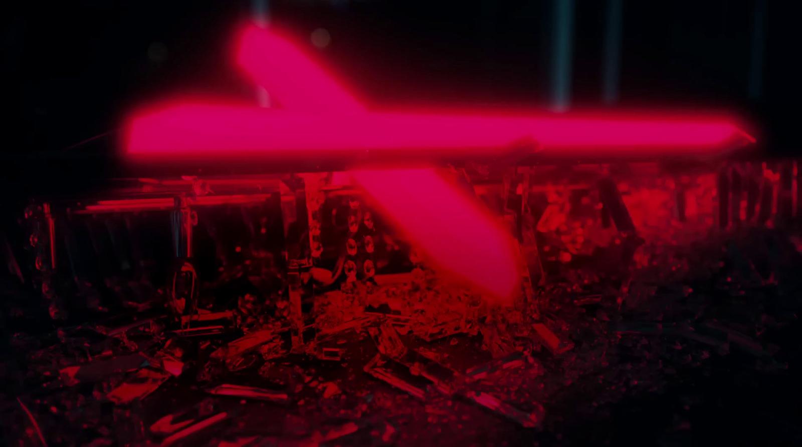 a red light is shining on a plane in the dark