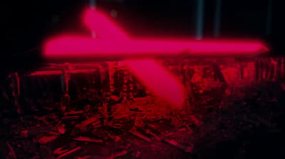 a red light is shining on a plane in the dark