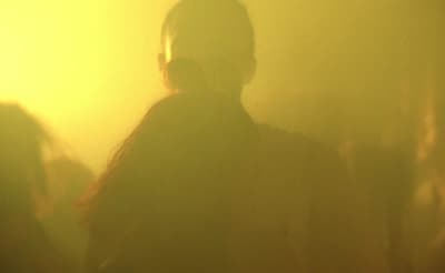 a group of people standing in a foggy room