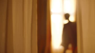 a blurry image of a person standing in front of a window