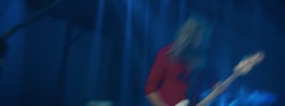 a blurry photo of a person playing a guitar